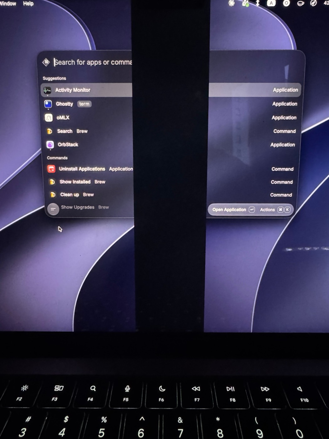 A MacBook screen with two vertical black bands of dead pixels running down it